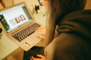 Digital marketer researching SEO extensions on a laptop for better workflow and content optimization.