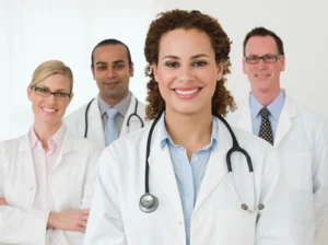 Smiling team of doctors in white coats ready to assist patients with professional care.