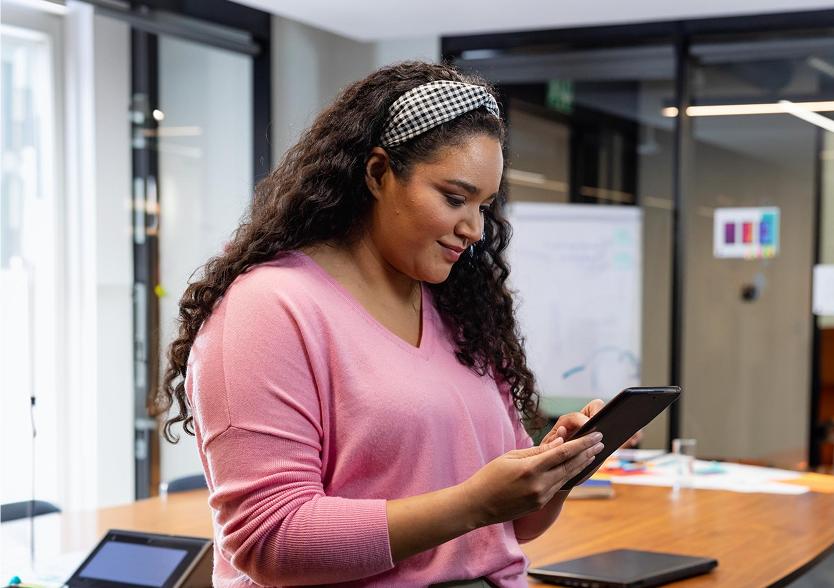Woman using a tablet in a modern office.